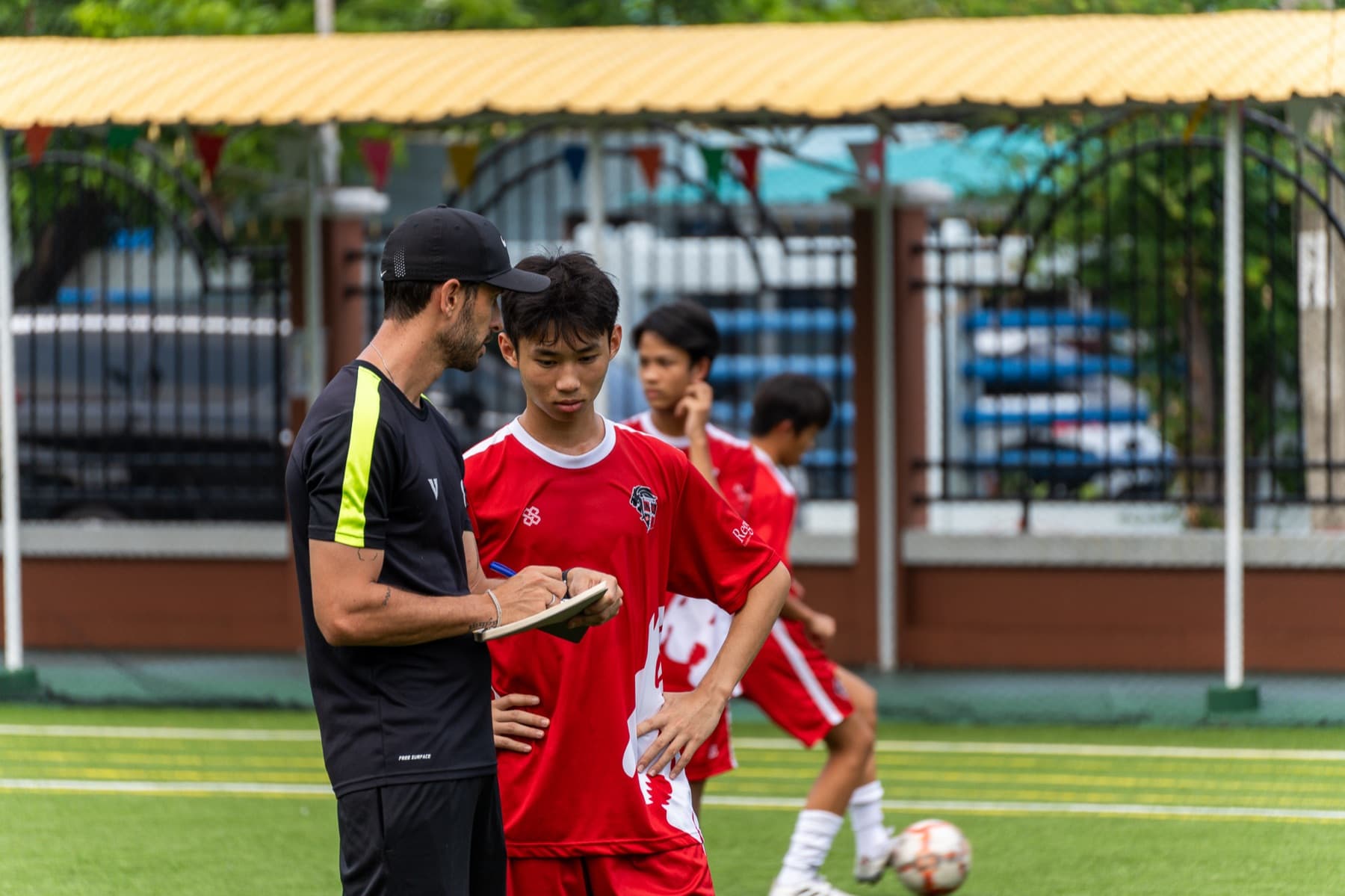 Tactical notes with a Regents player during warm-up