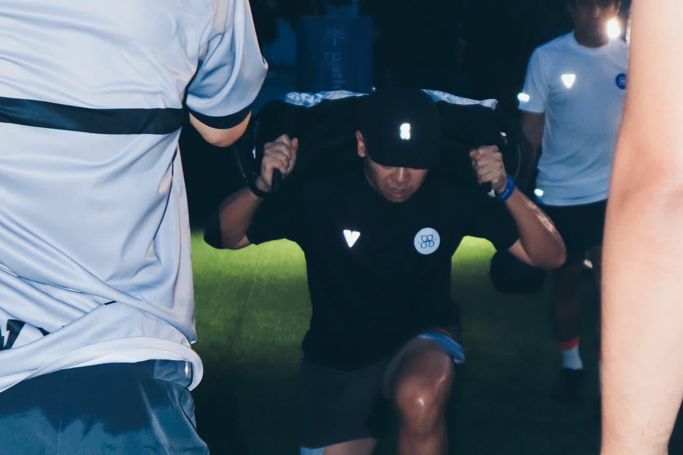 A participant working through the circuit under the floodlights after dark